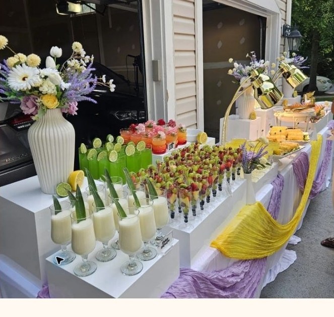 Elegant Omobee’s Kitchen buffet with colorful mocktails and appetizers